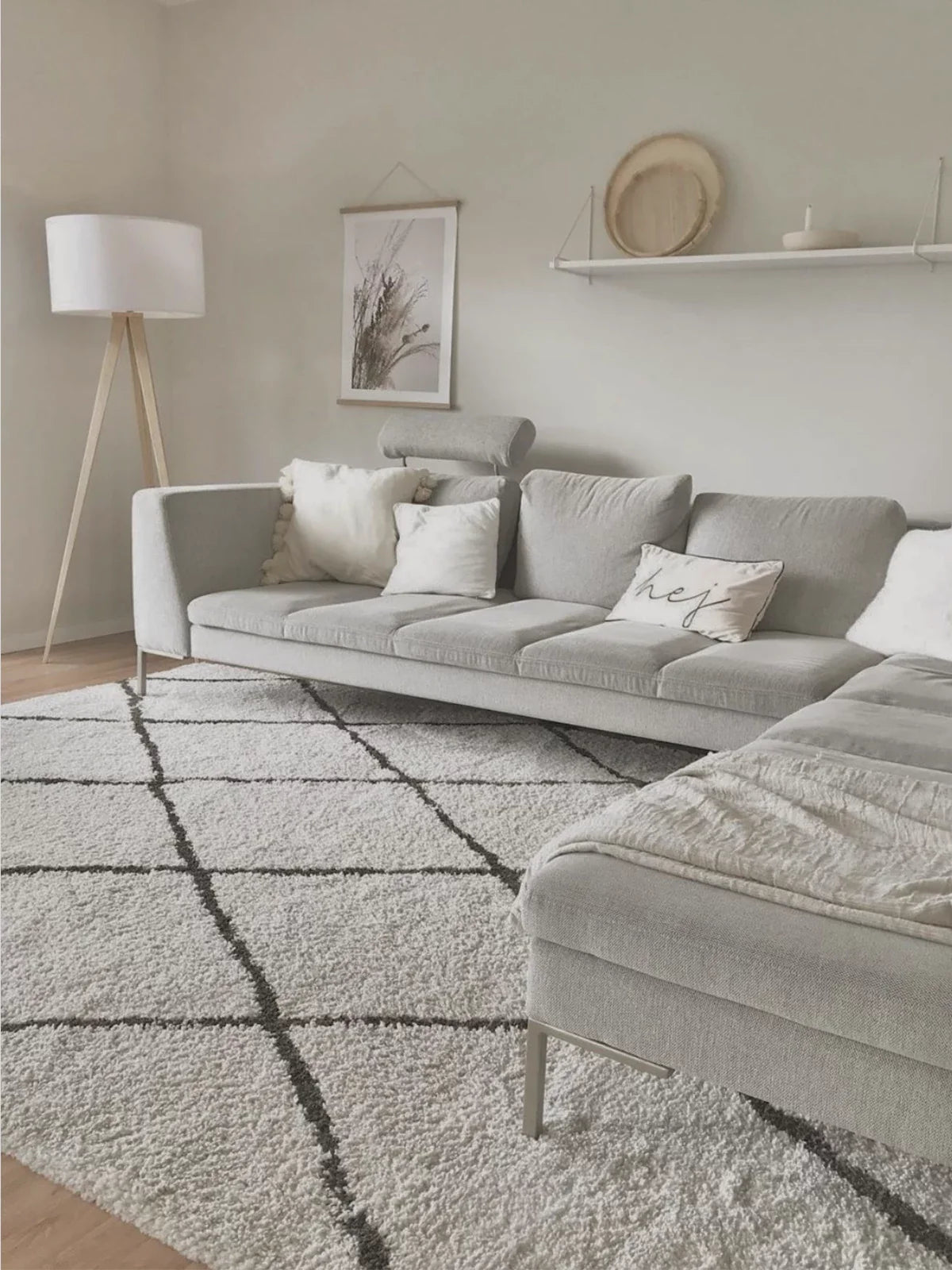 Modern, minimalist living room featuring a soft 8x10 washable rug with a geometric pattern, paired with a light gray sectional sofa and cozy decor.