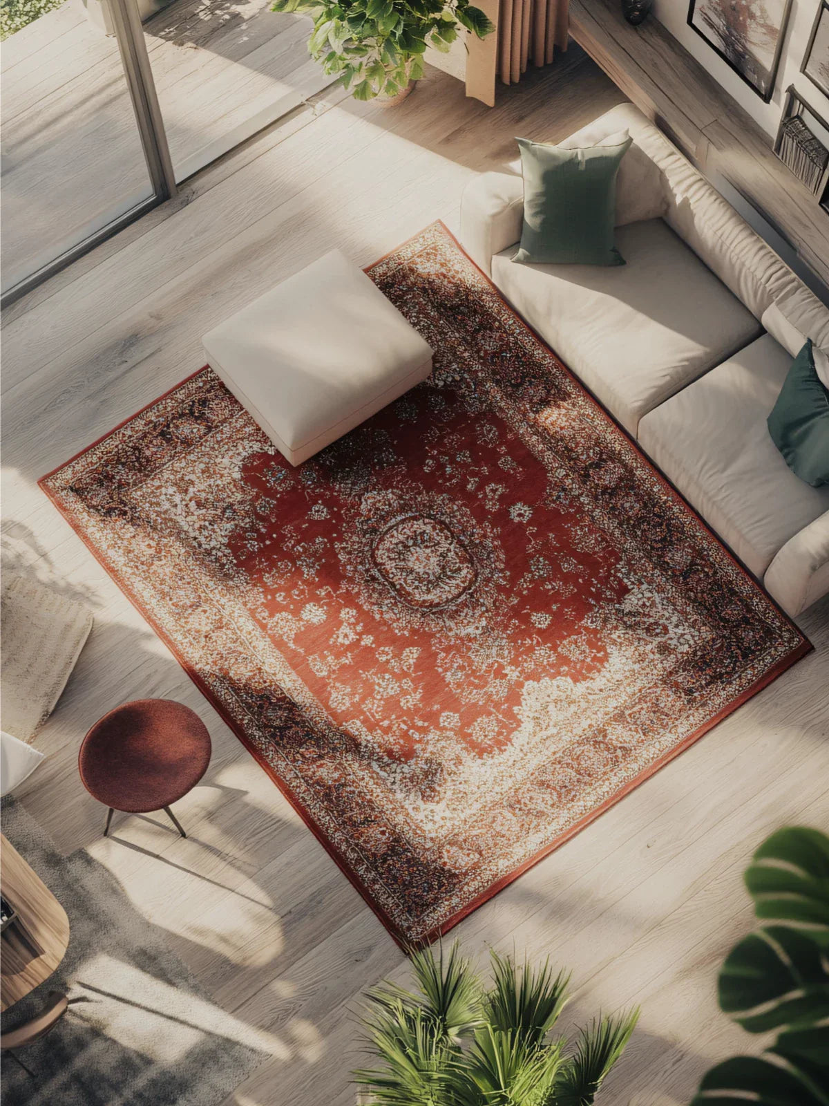 Elegant living room featuring a classic red bordered rug with intricate detailing, paired with a neutral sofa, modern decor, and abundant natural light.