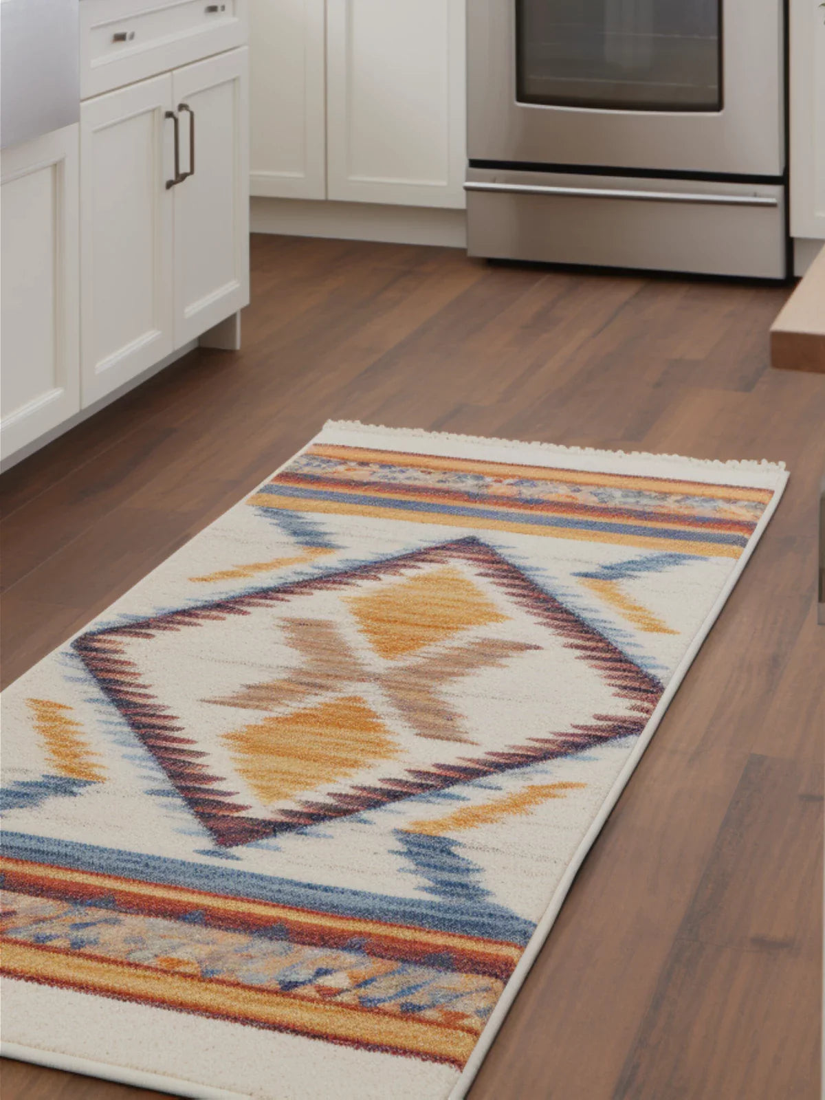 Colorful runner rug with tribal patterns placed in a modern kitchen with white cabinets and wooden flooring.