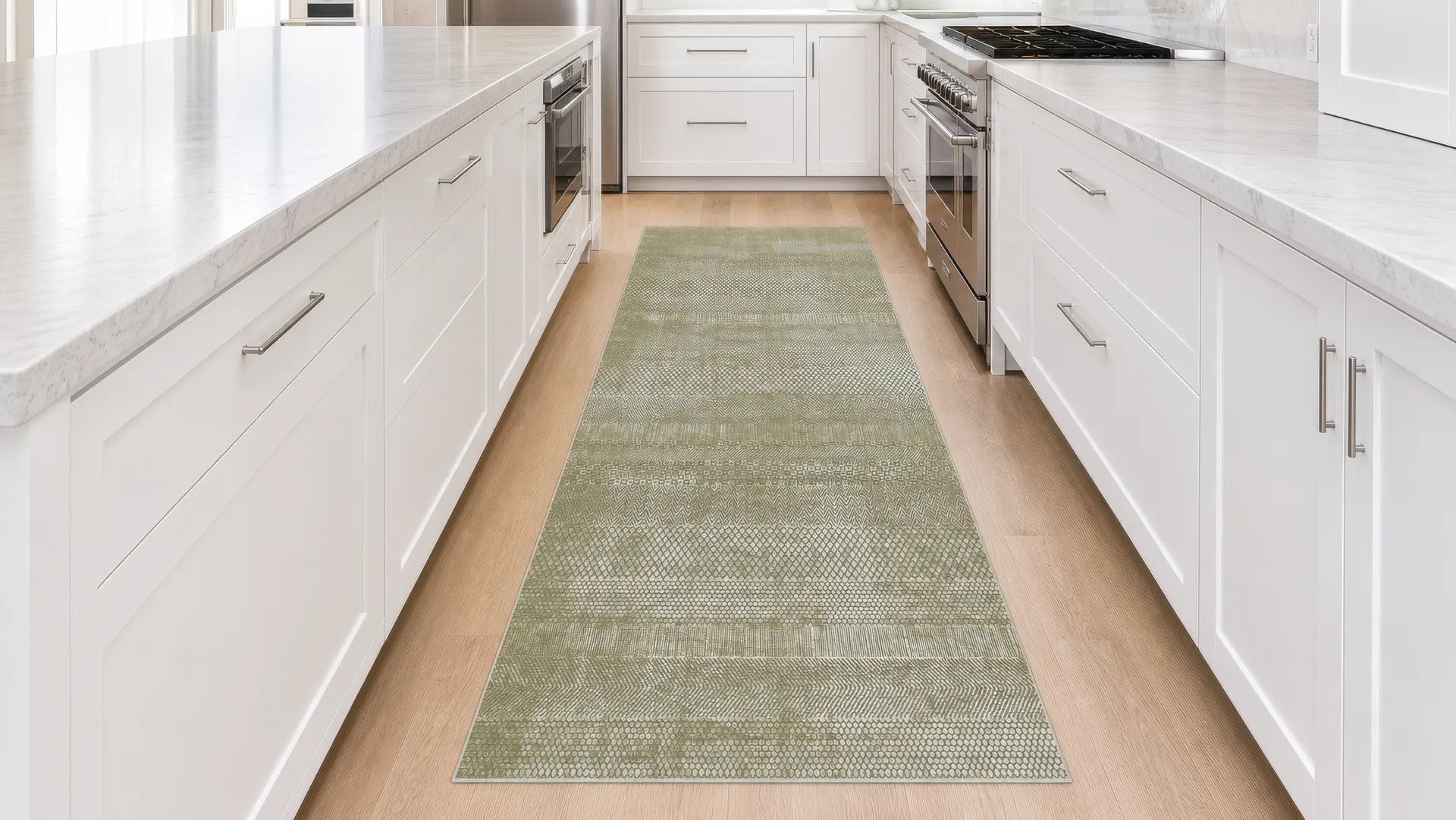 A rectangular and minimalist green runner rug with a textured woven pattern, laid out on a light wood floor in a modern kitchen with white cabinets and countertops.