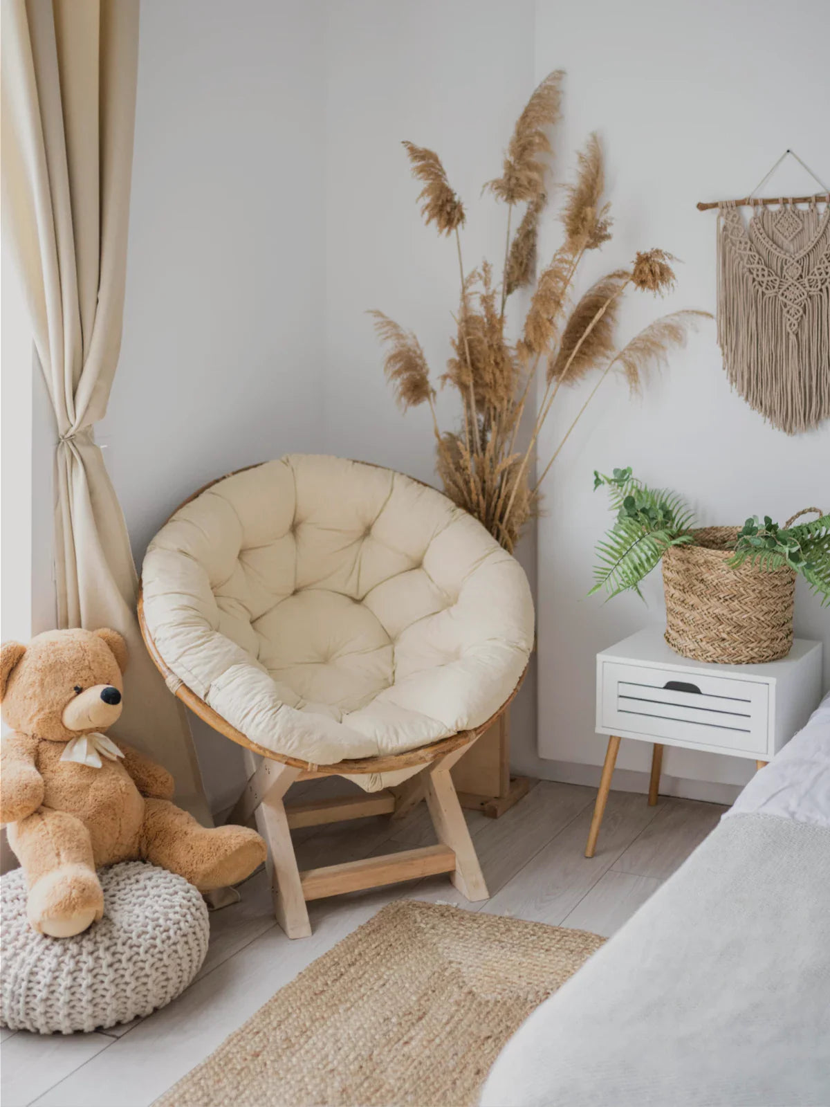 Cozy bohemian-style corner featuring a 2x3 jute rug, a plush papasan chair, a woven basket, and soft neutral decor.