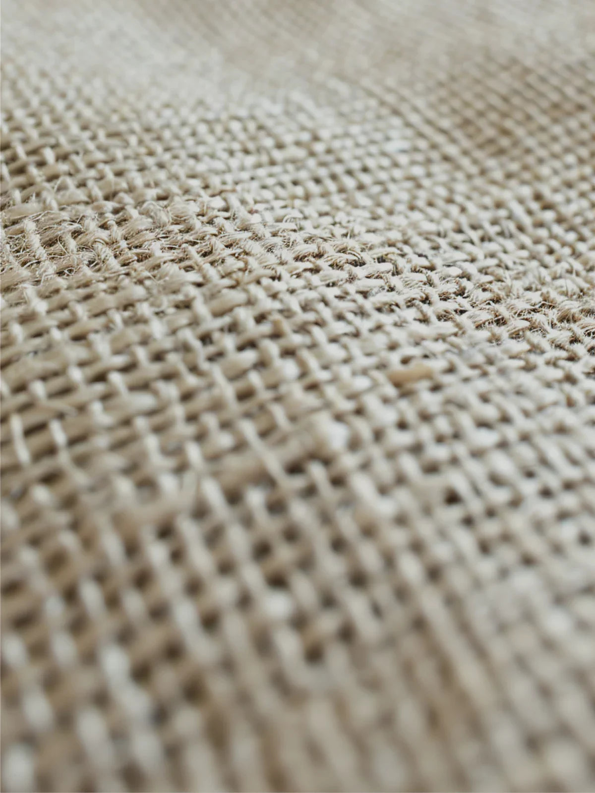 Close-up of a 9x12 jute rug showcasing its intricate woven texture and natural fiber construction for a rustic aesthetic.