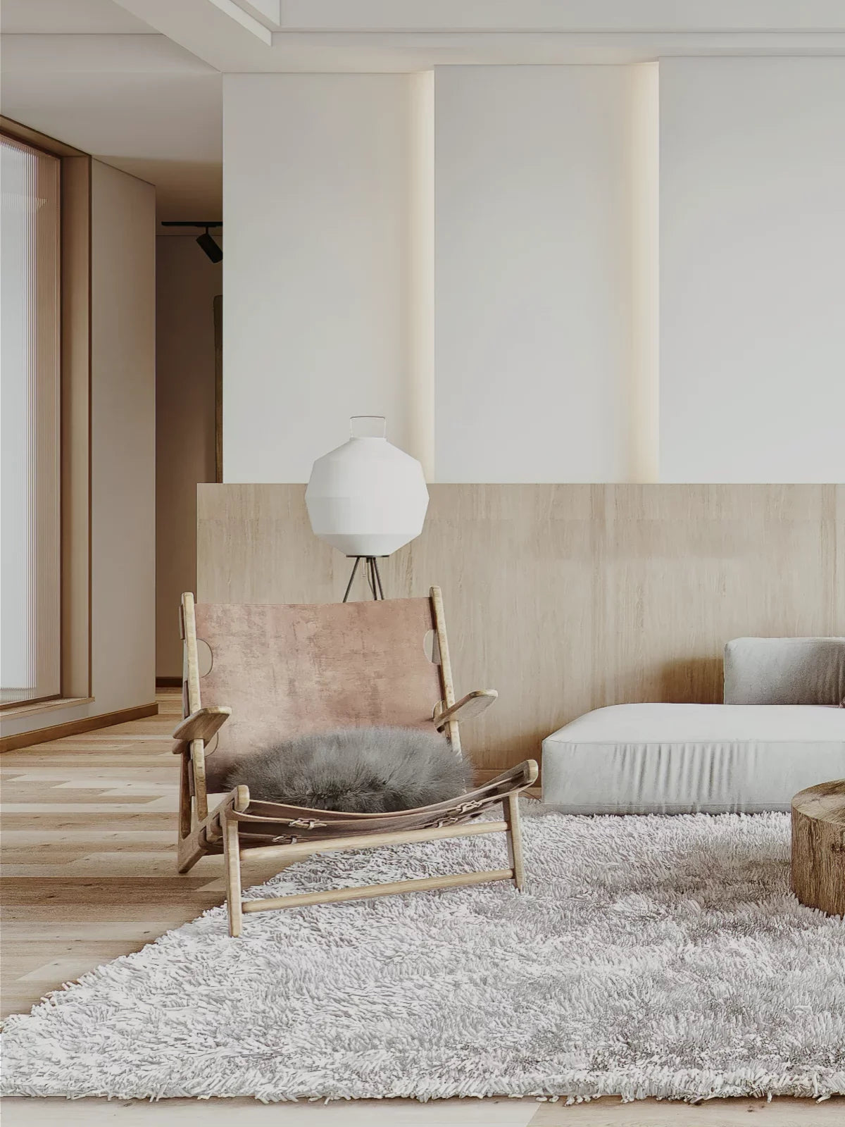 Modern living room with a soft, plush micro rug in neutral tones, complemented by a leather accent chair and minimalist decor.