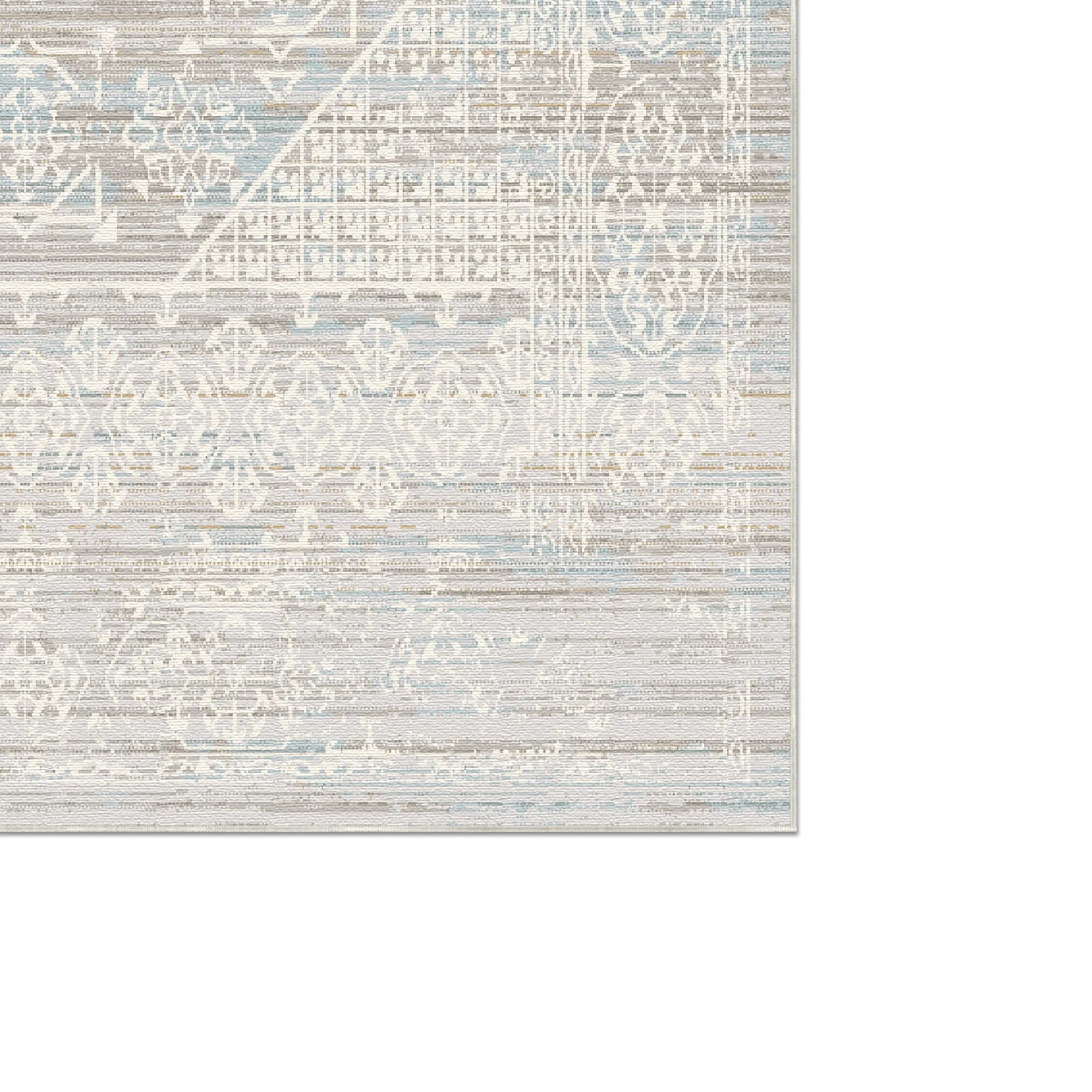 area rug with light blue gray and beige geometric and floral patterns on white background