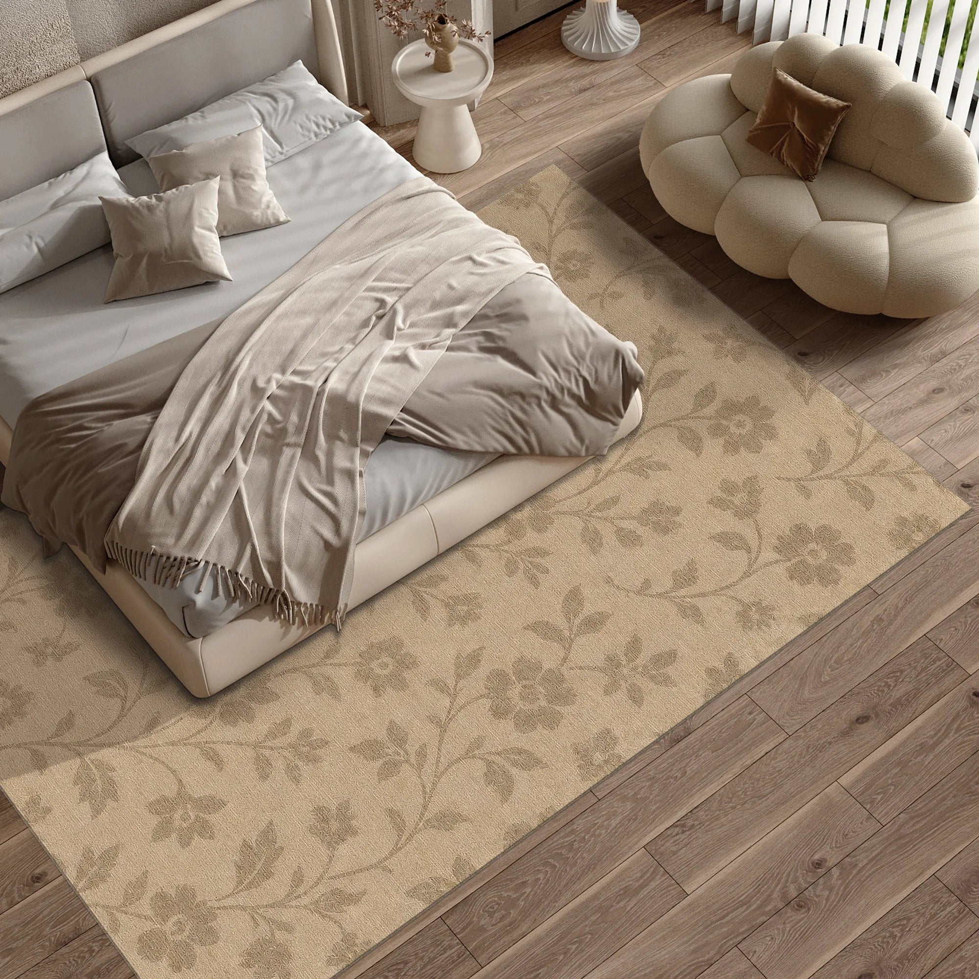 Neatly made bed with beige bedding on a floral-patterned rug in a bedroom.