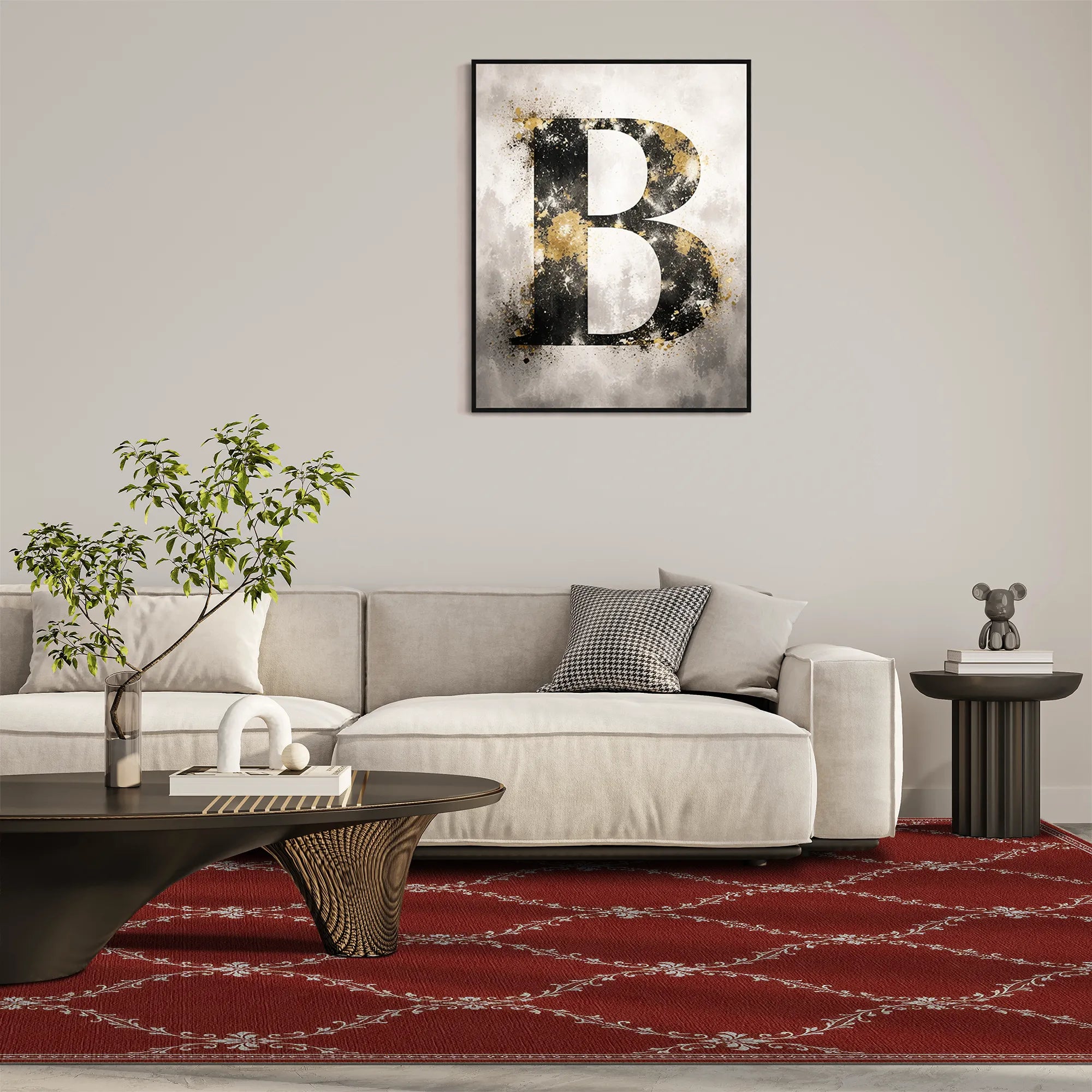 A red lattice rug with a framed abstract art print featuring a large textured letter 'B' in black and gold on a smoky gray background, displayed on a light gray wall above a modern beige sofa in a styled living room.