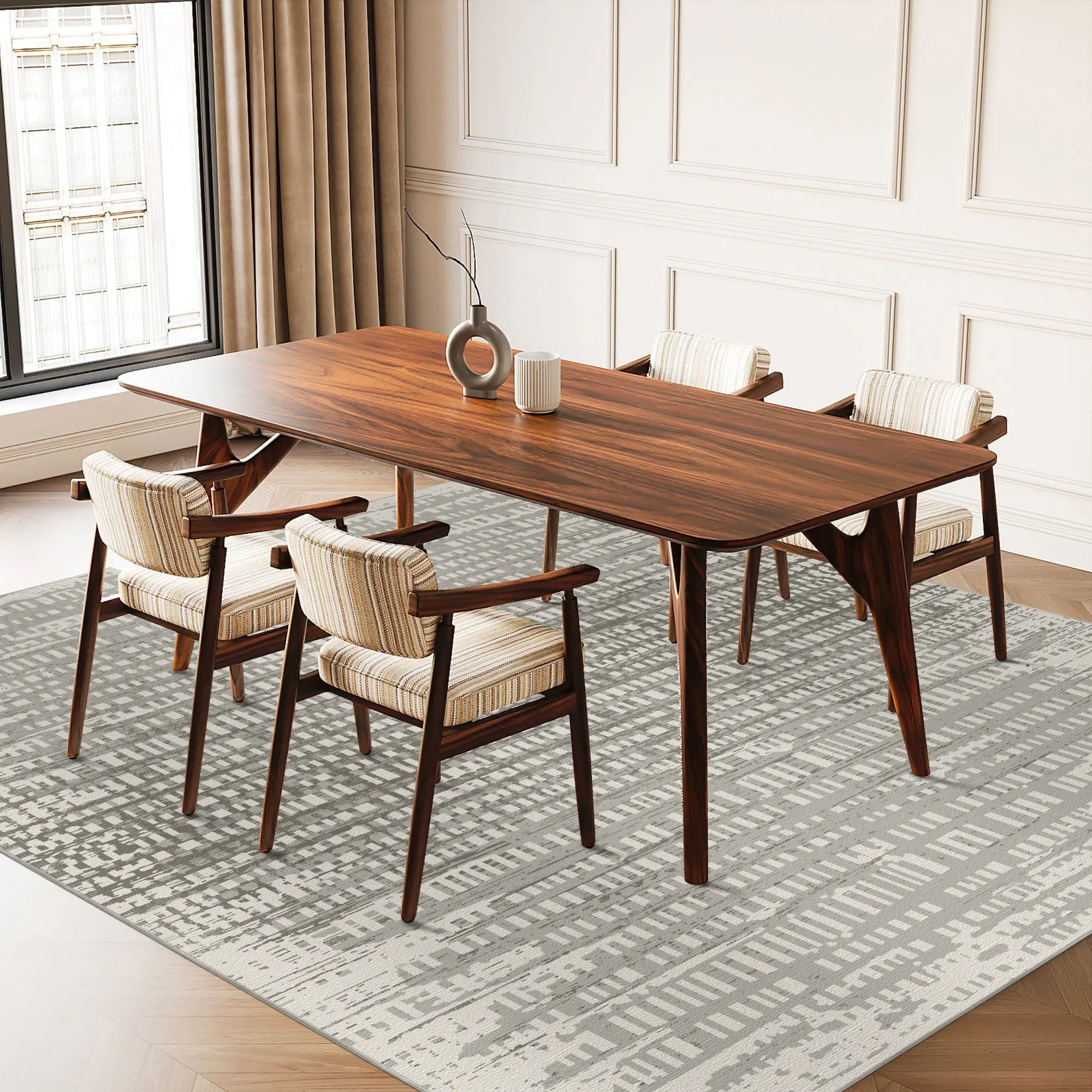 Gray and cream area rug with digital glitch pattern under dining table and chairs
